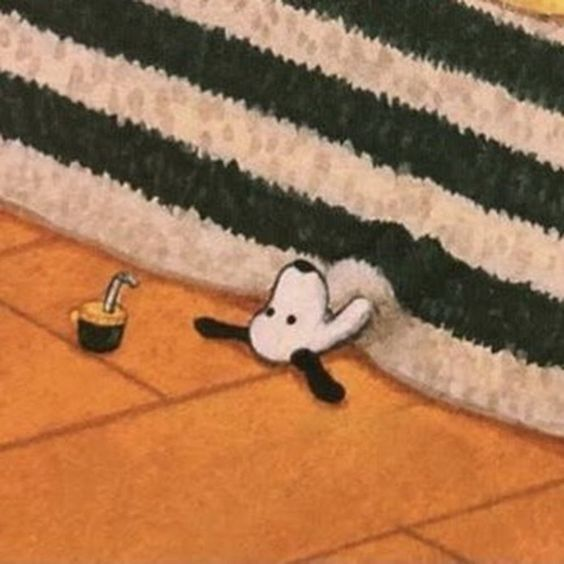 Imagen de Snoopy recostado en el piso bajo una manta a rayas